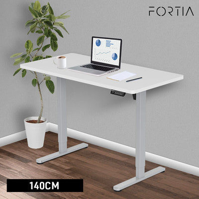 FORTIA Sit To Stand Up Standing Desk, 140x60cm, 72-118cm Electric Height Adjustable, 40kg Rated, White/Silver Frame