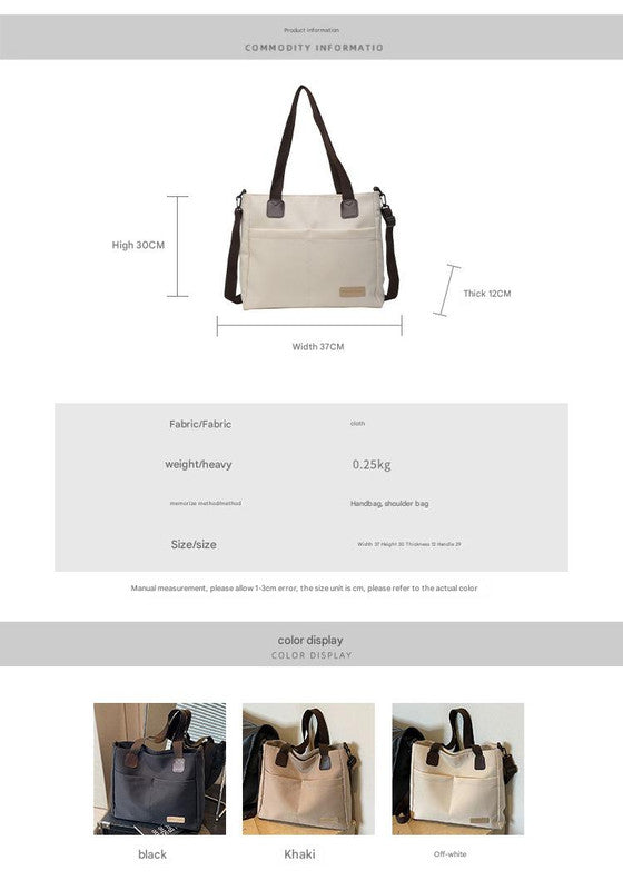 Stylish black canvas tote bag with detachable shoulder strap