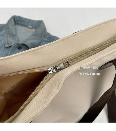 Stylish black canvas tote bag with detachable shoulder strap