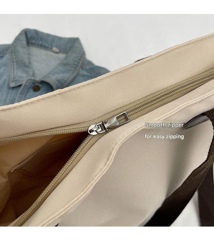 Stylish black canvas tote bag with detachable shoulder strap