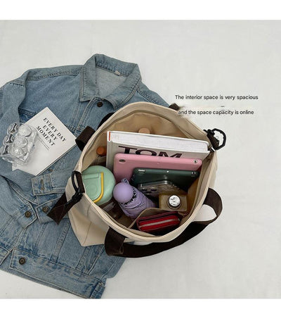 Stylish black canvas tote bag with detachable shoulder strap