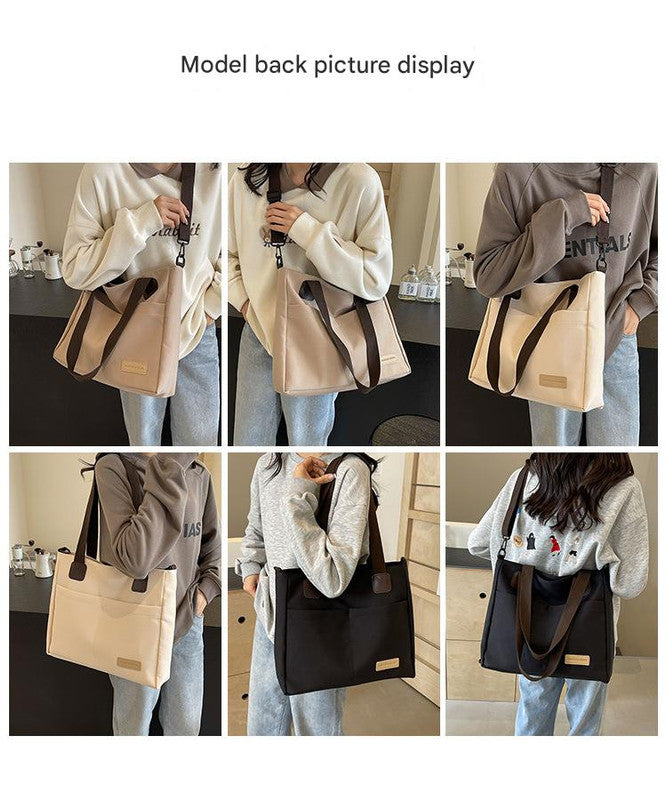 Stylish black canvas tote bag with detachable shoulder strap